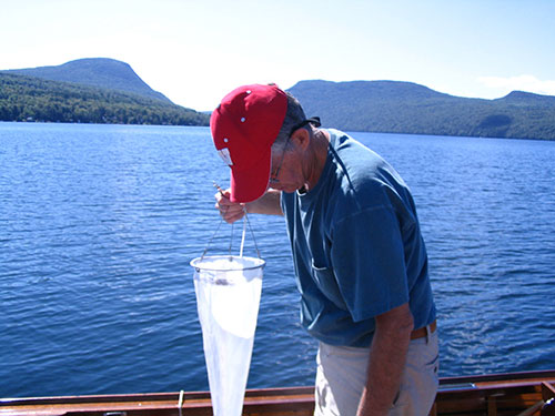 Limnologist-Plankton-net-and-mountains.jpg